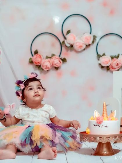 The birthday girl, dressed in her rainbow tutu, looking up in wonder before the fun begins. I always take some clean, classic portraits before the cake is introduced.