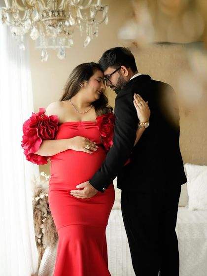 A tender moment between the parents-to-be, while their daughter stands close by, part of this beautiful family story.