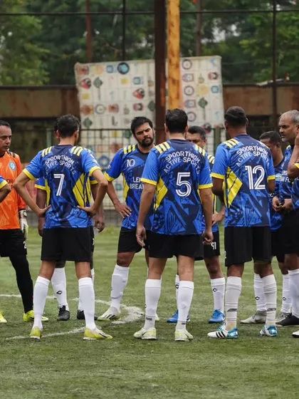 A tactical team huddle during a crucial moment in an 11-a-side game. Strategy and teamwork are at the core of how we approach every match in the Mumbai veterans league.