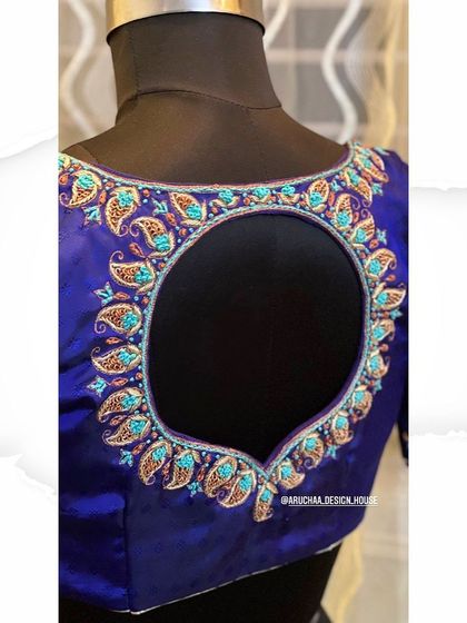 A closer look at the handcrafted zardosi work on the blue blouse, showing the intricate details of the paisley pattern.