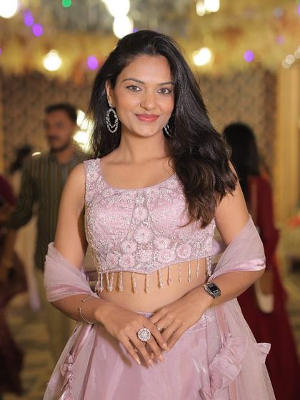 A full shot of the client in the lavender lehenga, looking poised and beautiful.