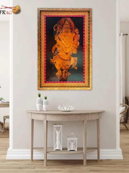 A stunning Tanjore painting of Ganesha, enhanced by an ornate, antique-style gold frame that befits its divine subject.