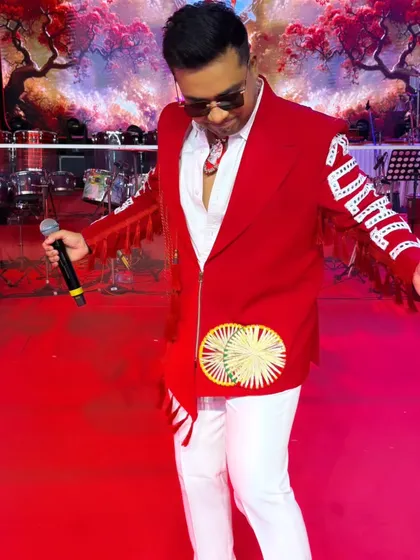 A moment of reflection on the red carpet before the show. My vibrant red jacket for Day 2 was designed to command attention.