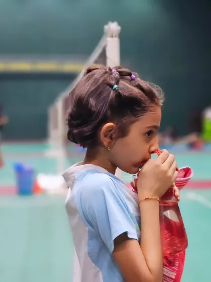 A quick hydration break for one of our youngest players. Staying hydrated is crucial during our intense sessions.