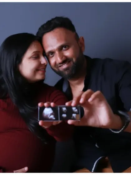 A loving portrait of the expecting parents holding their ultrasound scan, their faces filled with happiness and excitement for their new arrival.