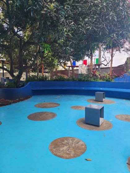 We designed this vibrant blue outdoor seating area and landscape as a quick and creative solution to enhance a public space, adding both color and function.