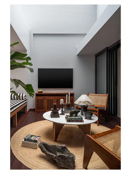 Another angle of the master bedroom lounge, showing the custom bench, caned armchairs, and media unit. I design furniture to create cohesive, multi-functional spaces that feel both luxurious and lived-in.