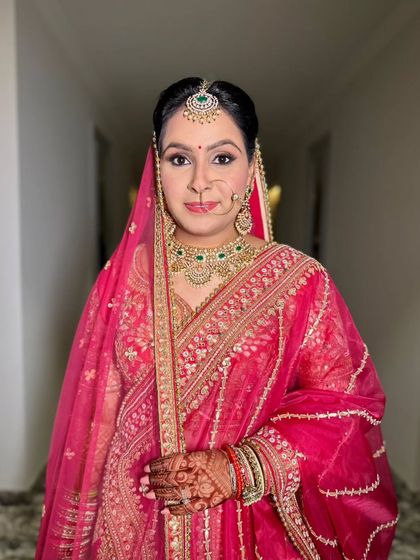 A confident and poised portrait. The makeup is timeless and elegant, designed to enhance her natural beauty.