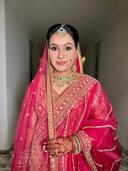 A confident and poised portrait. The makeup is timeless and elegant, designed to enhance her natural beauty.