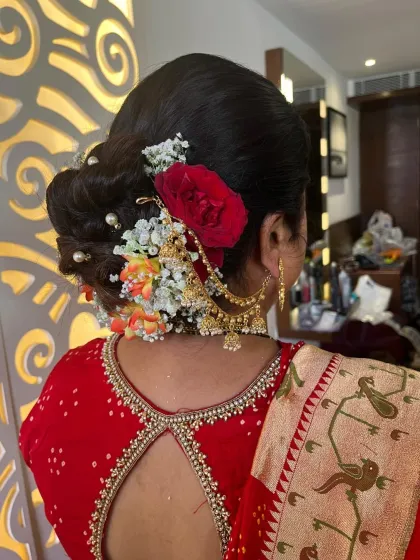 Another angle of this beautiful floral bun, showing the placement of the red rose and baby's breath.