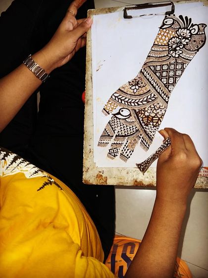 A student in my professional bridal course practicing a full-hand design on paper. This is how we build muscle memory and precision before working on skin.