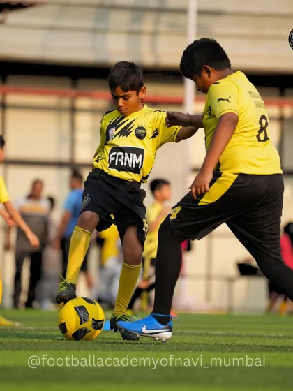 A player uses his strength to hold off a defender while maintaining control of the ball.