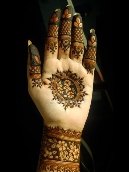 This minimalist design features a floral mandala on the palm and a matching floral cuff on the wrist, leaving the fingers open for a clean, modern look.