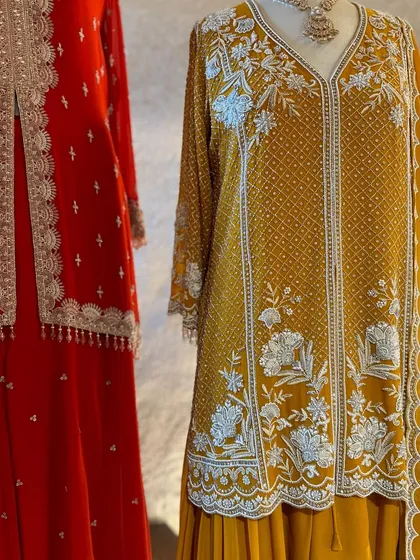A close-up of this mustard yellow kurta reveals the intricate white floral embroidery, a beautiful example of detailed threadwork that elevates the entire outfit.