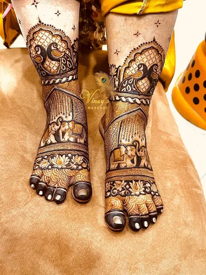 A different angle of the bridal foot mehndi, showing how the peacock and elephant motifs wrap around the ankle.