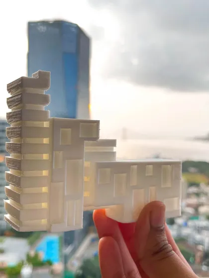 Here, we bridge the gap between concept and reality. This image shows a conceptual 3D printed model of a future high-rise, held against the very skyline it is designed to join, illustrating our hands-on, forward-thinking design process.
