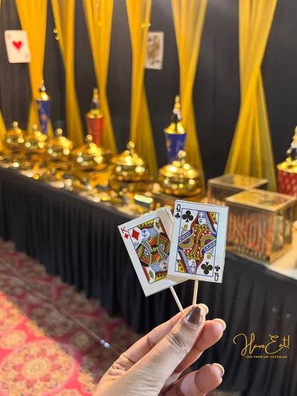 A close-up of the card-themed food toppers used for our Diwali party catering, showing our attention to the smallest details.