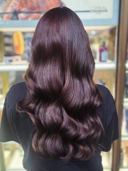 A deep, rich auburn global color styled into glamorous, old-Hollywood waves.