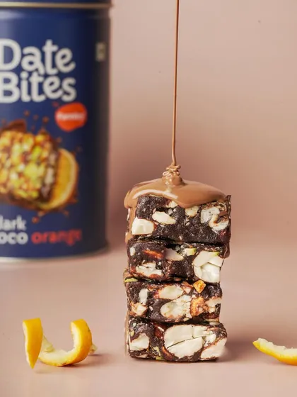 A close up action shot of chocolate being drizzled over these delicious Date Bites. I focus on capturing textures and moments like this to make the food look as irresistible as it tastes.
