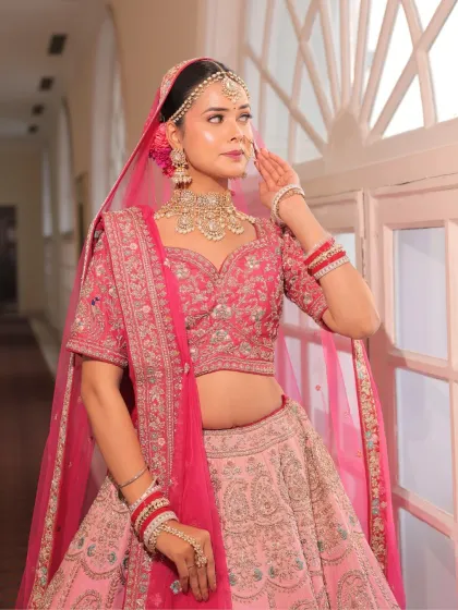 This bride's pose exudes confidence and grace. Her makeup, with its warm pink eyes and radiant base, is a perfect match for her modern bridal style.
