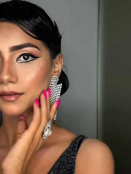 A full view of the finished graphic liner look, complete with flawless skin and a retro-inspired hairstyle. This is a perfect example of a complete party or editorial look.