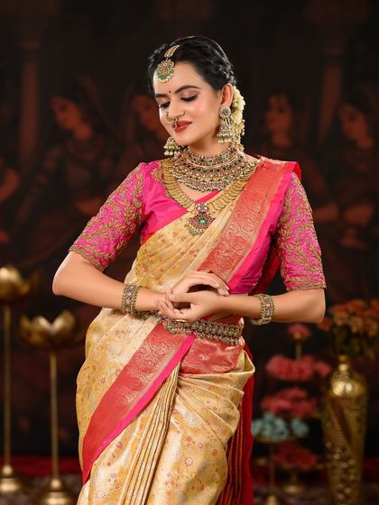 A graceful pose showing the intricate details of the bride's attire. The makeup is kept classic to complement the traditional aesthetic.