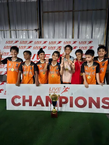 Our U9 champions posing for a team photo. Their smiles show how much this victory means.