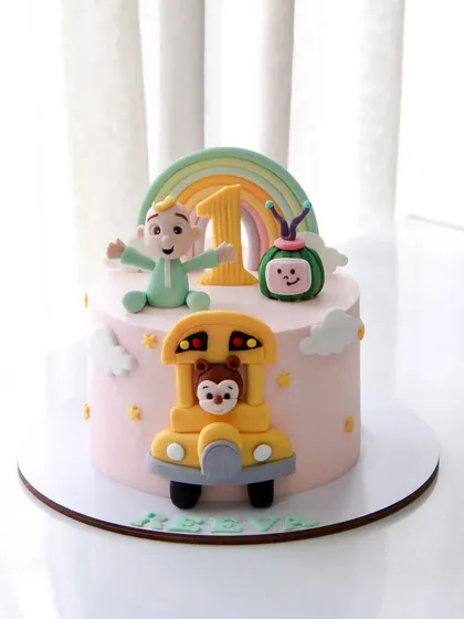 The cutest Cocomelon theme cake for a 1st birthday. This design features JJ, the iconic melon, and the yellow school bus, all handcrafted to bring the beloved show to life.
