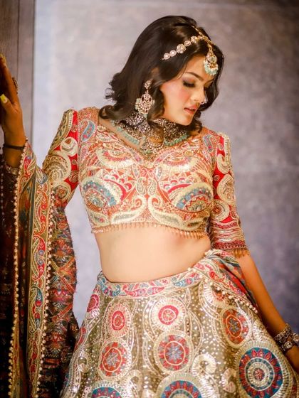 Draped in elegance, this multi-color embroidered lehenga is a masterpiece. The bell sleeves and detailed dupatta add a unique touch for a modern bride.