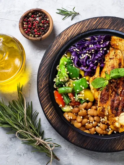 A beautifully plated high-protein bowl featuring grilled chicken, red cabbage, beans, and fresh veggies. This is how I make sure your healthy meal is also a feast for the eyes.
