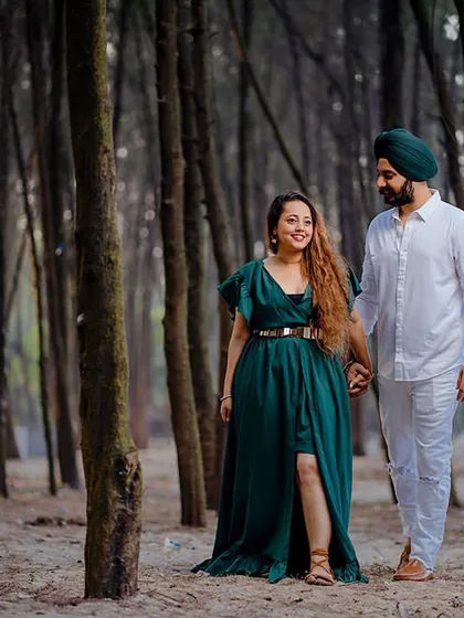 Avneet and Lavleen walk hand-in-hand through a coastal forest. The tall, slender trees create a unique and enchanting frame for this pre-wedding shot.