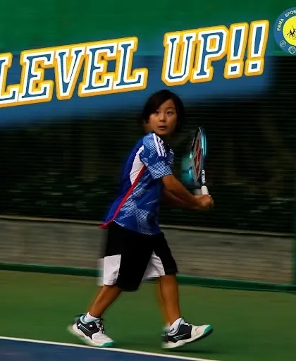 A young player in mid-swing, ready to level up his game. At my academy, we let the racquet do the talking.