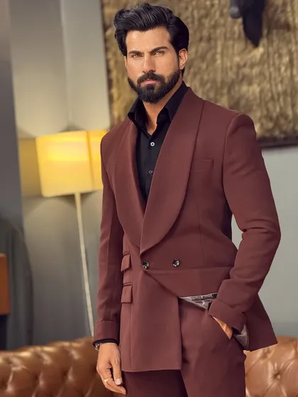 Discover the rich texture and elegant drape of our shawl lapel suit in a deep brown. This ensemble is a sophisticated alternative to traditional black, perfect for evening functions and formal gatherings where distinguished style is key.