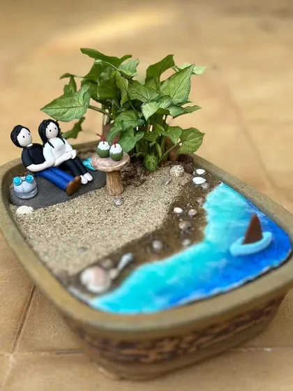 Another view of the custom couple's mini garden, showing the resin water effect and the tiny boat.