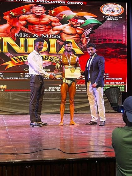 Ankit Rajput being awarded his medal on the Mr. India stage. A proud moment for him and for me as his coach.