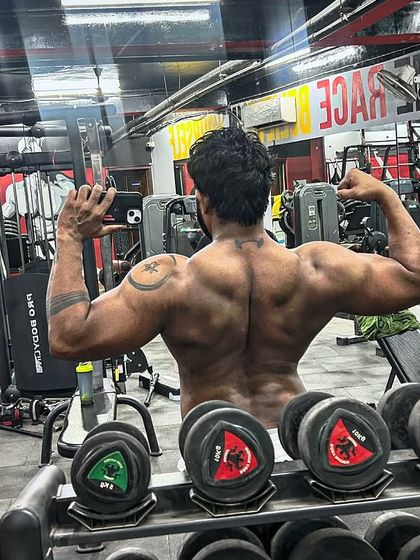 A back shot in the mirror, checking the symmetry and definition.