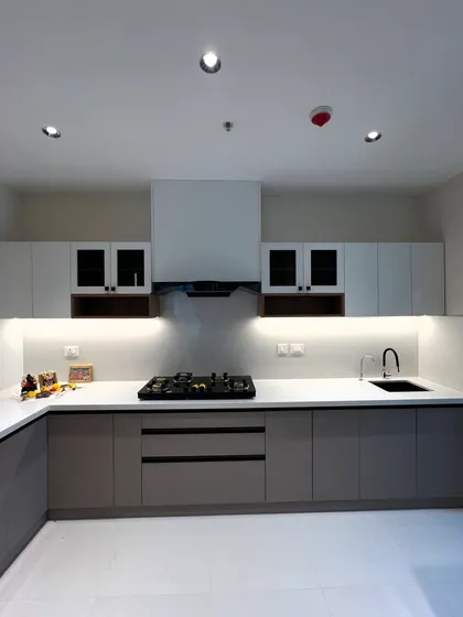 Another angle of the modern two-tone kitchen, showing the clean countertop lines and the layout of the cooking and sink areas.