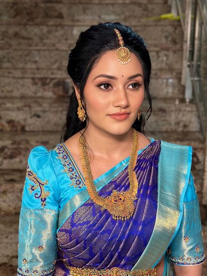 A minimal modern glam look in a beautiful blue and turquoise Kanjivaram saree, perfect for a special day.