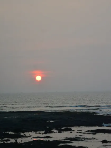 The sun sets softly over the sea, casting a beautiful glow. This serene view is a daily reminder of the natural beauty that surrounds our sports complex.