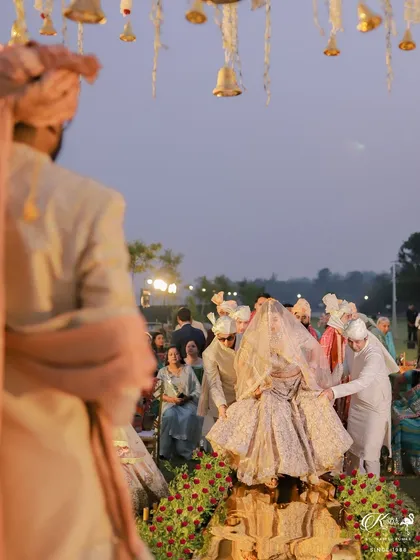 The groom watches as his bride makes her grand entrance, carried on a doli. We capture the anticipation and emotion from both perspectives.