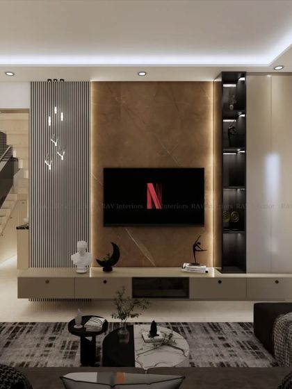 A wider view of the living room, showing the TV unit in context with the seating area and staircase. The color and material palette creates a warm and luxurious feel.