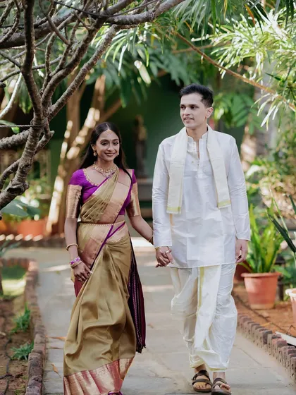 A couple walks hand-in-hand down a garden path, a simple and timeless shot that captures the beginning of their shared life.