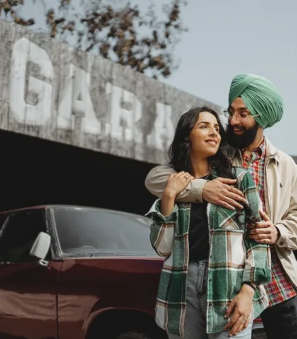 A cool and casual shot of Manpreet and Simran in front of a vintage garage set. This shows our ability to create concept shoots that reflect a couple's unique style.