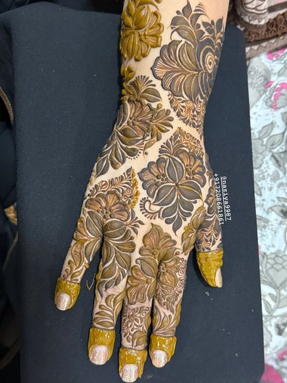 A close-up of a full-hand floral design. The different sizes and shapes of the flowers create a beautiful, textured pattern.