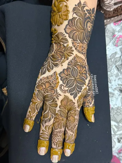 A close-up of a full-hand floral design. The different sizes and shapes of the flowers create a beautiful, textured pattern.