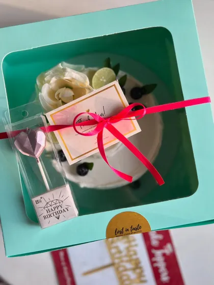 Here's how my signature Lemon Blueberry cake looks when it's all packed up and ready to go, complete with a candle and thank you card for your special occasion.