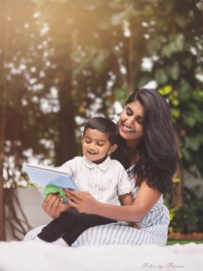 A mother and son reading a book together outdoors. These lifestyle shots are a wonderful way to capture everyday moments.