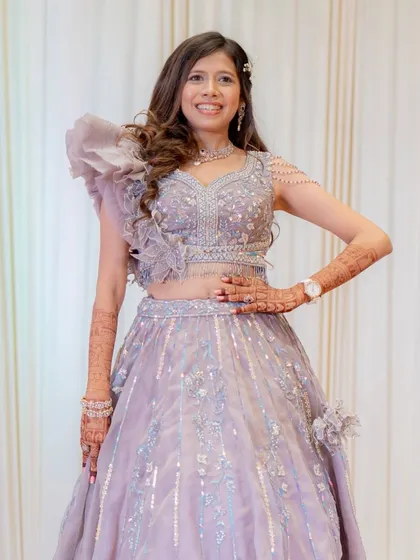 The full view of this bride's stunning lavender engagement gown. The makeup is kept soft and elegant to balance the dramatic silhouette.