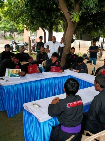 A meeting with students to discuss theory and review progress. Martial arts training is not just physical; it is also about understanding the principles behind the art.