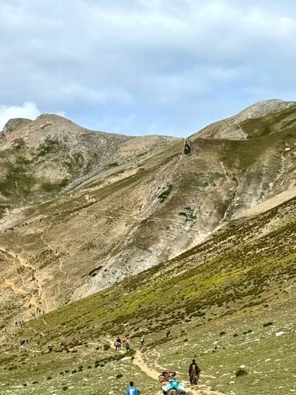 Our group of trekkers making their way along a high mountain trail. The sense of shared adventure and determination is a core part of the experience.